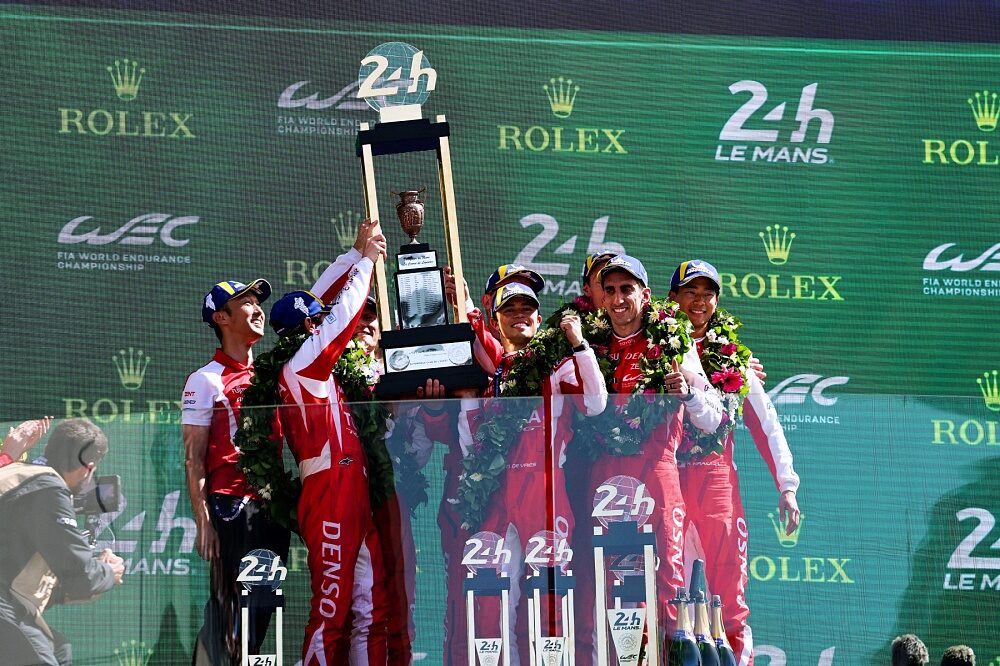 Toyota Racing number 7 trio lift the Le Mans trophy on the podium