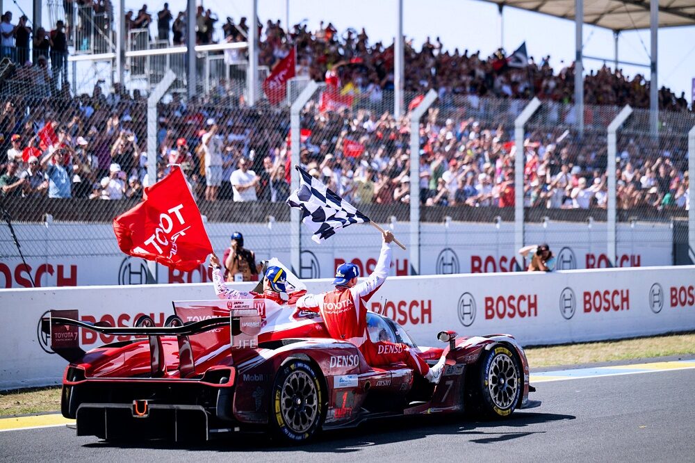 Toyota TR010 HYBRID number 7 celebrates victory on the Le Mans straight