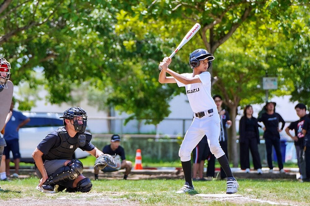 Thailand U12 youth baseball player bats during field practice