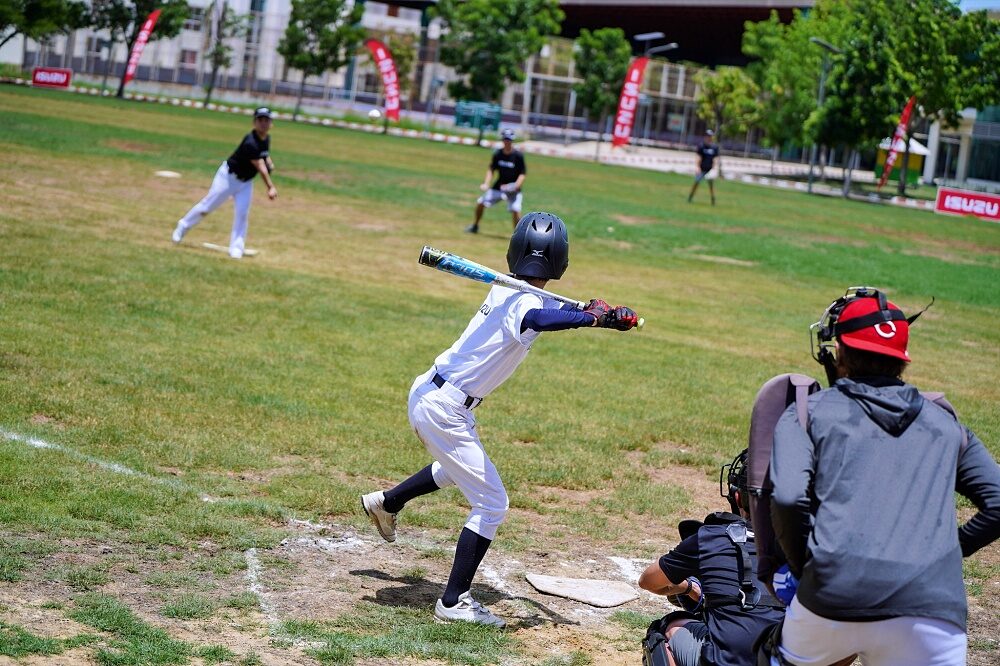 Thailand U12 youth baseball player bats with catcher behind