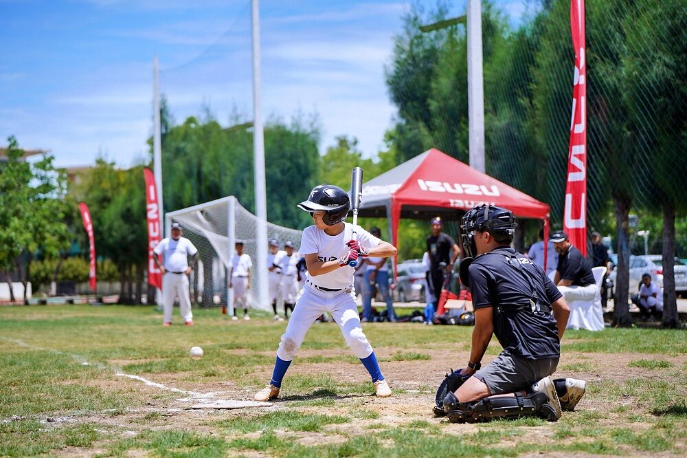 Thailand U12 youth baseball player practices batting on the field