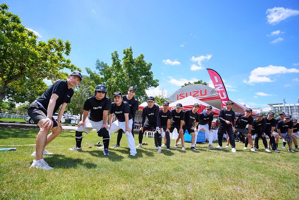 Isuzu Group executives in baseball uniforms pose on the field