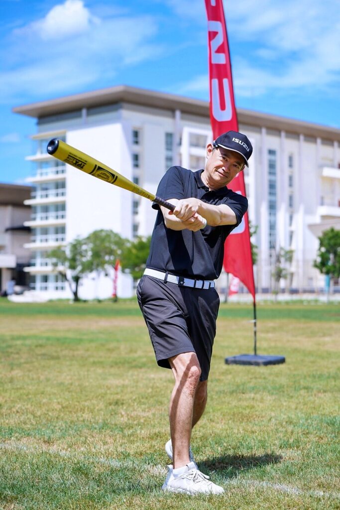 Hiroyasu Sato on the baseball field during the Isuzu activity