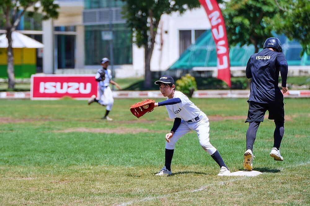 Thailand U12 youth baseball player throws during a practice game
