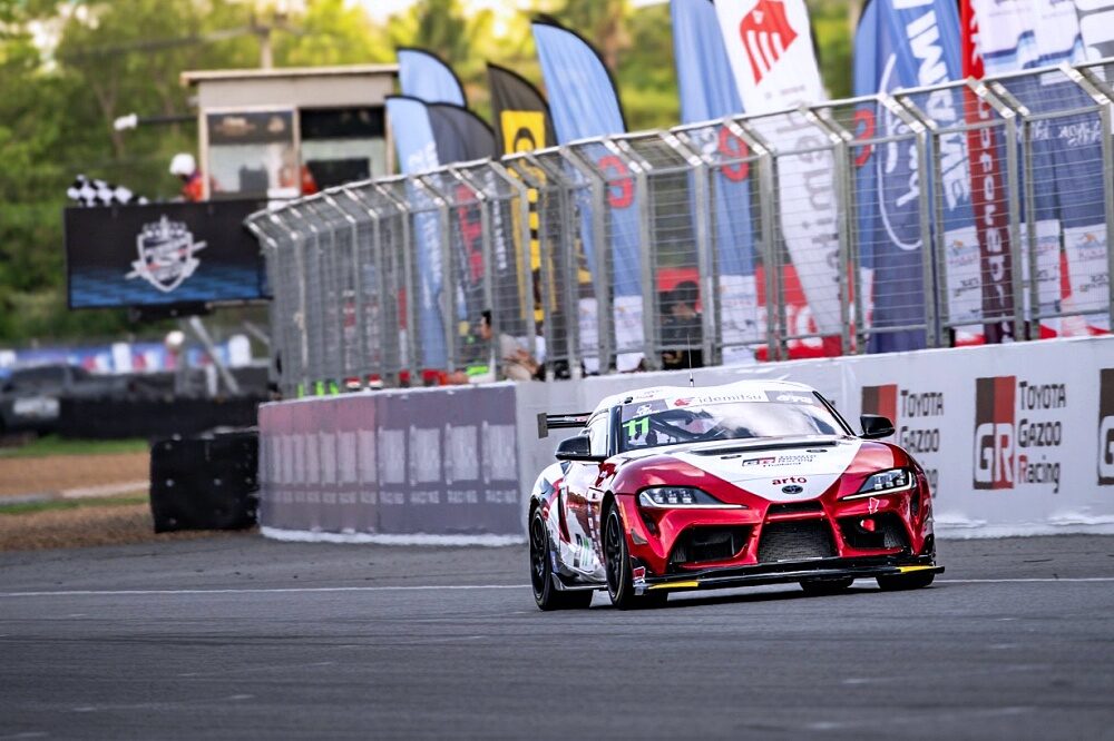 รถแข่ง Toyota Gazoo Racing สีแดงผ่านจุดแข่งขันในสนาม