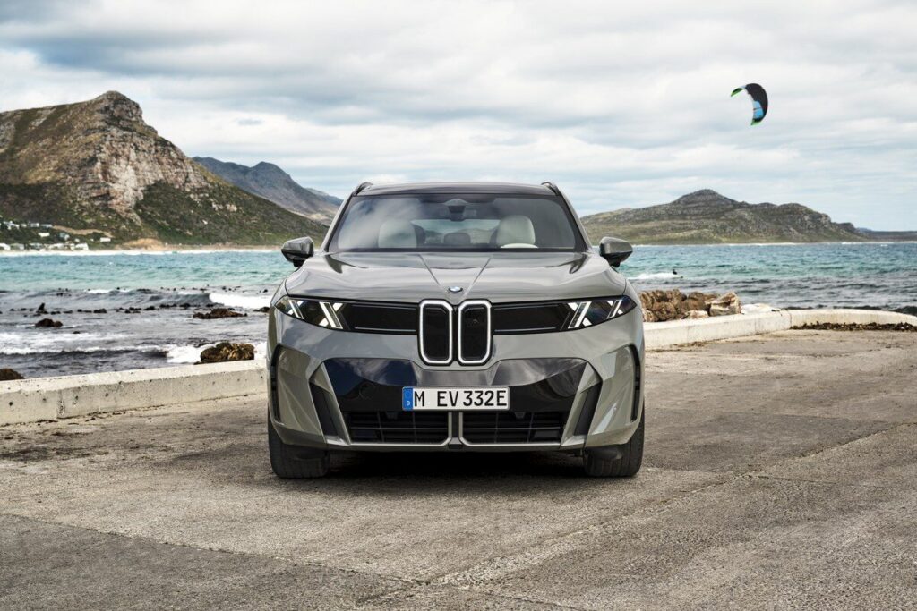 BMW iX5 60 xDrive 2026 มุมหน้าตรงริมชายฝั่ง