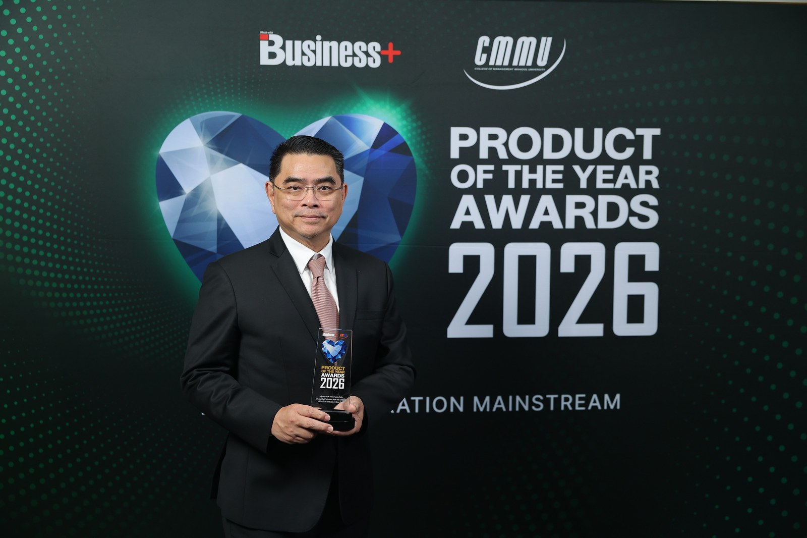 ผู้บริหารในชุดสูทถือรางวัล Product of the Year Awards 2026 หน้าฉากด้านหลังงาน