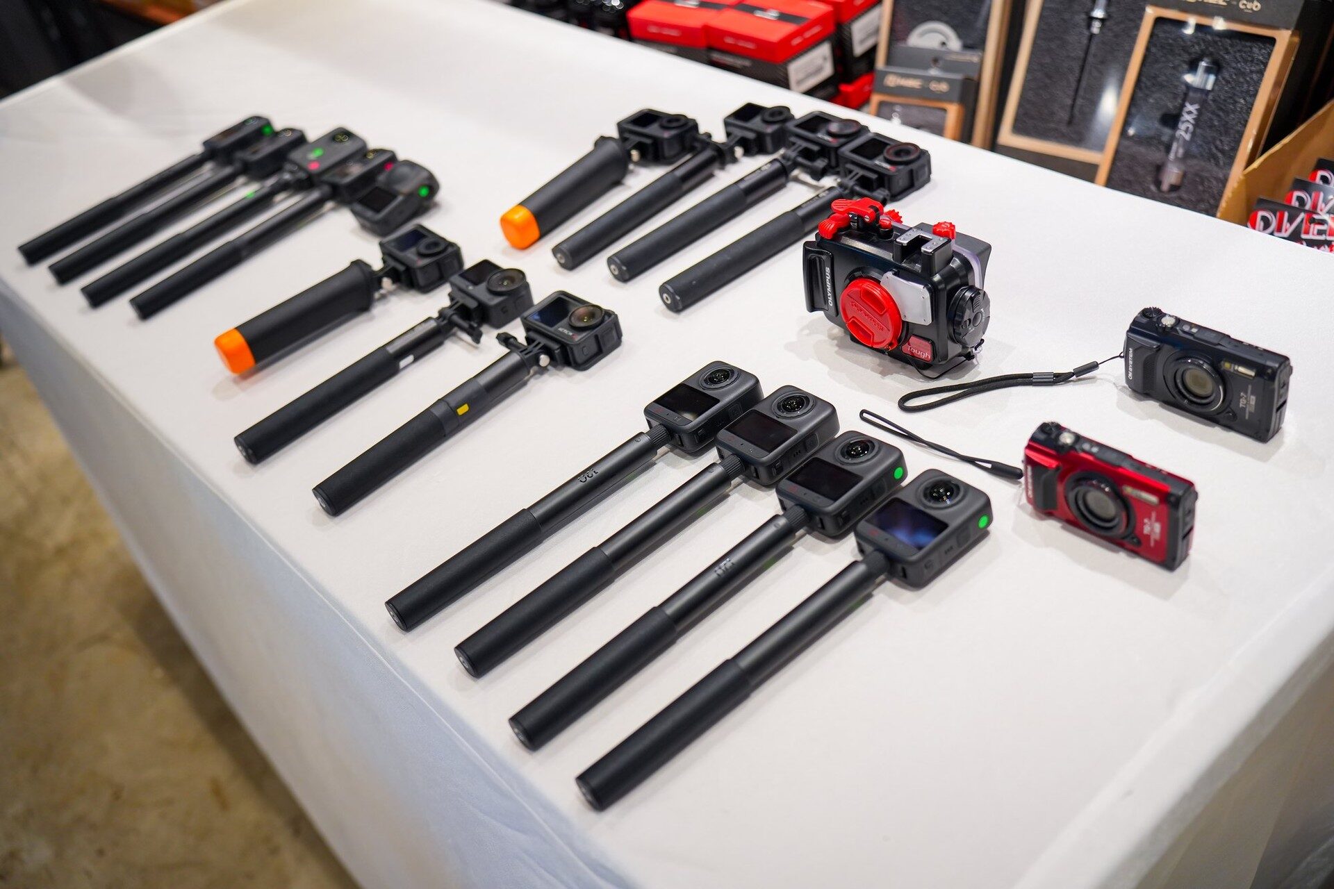 กล้อง OM SYSTEM TG-7 และกล้อง DJI Osmo วางเรียงบนโต๊ะสำหรับให้ผู้ร่วมทริปยืมใช้